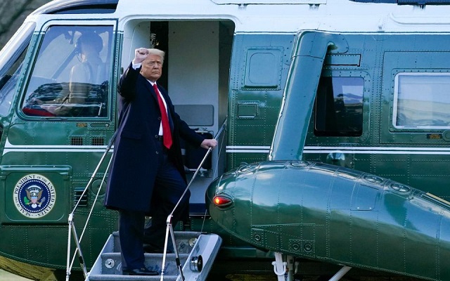 President Donald Trump gestures as he boards Marine One on the South Lawn of the White House,